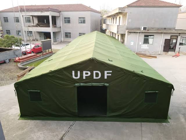 Green army tents and field accommodation shelters in Uganda – rugged, durable tents for military and humanitarian field operations, set up in a remote location.