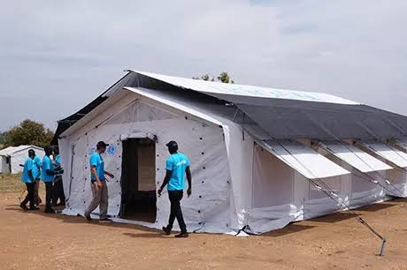 Family relief tents and emergency shelter kits in Uganda – portable, easy-to-assemble tents with blue and white covers, ready for distribution to displaced families.