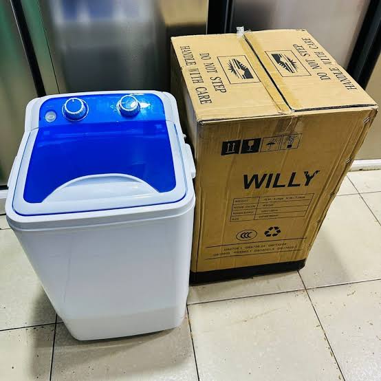 Assorted WASH supply kits – hygiene packs, water purification tablets, soap, jerry cans, and collapsible water tanks arranged for NGO distribution in Uganda.